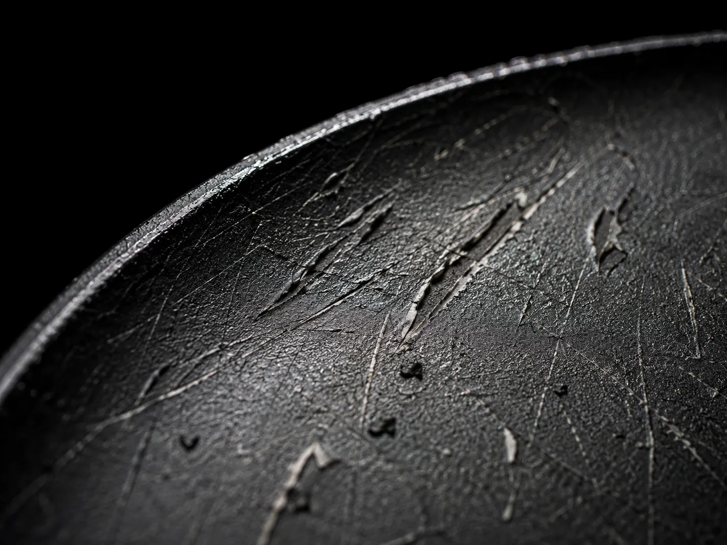 Macro close-up of scratched non-stick pan coating