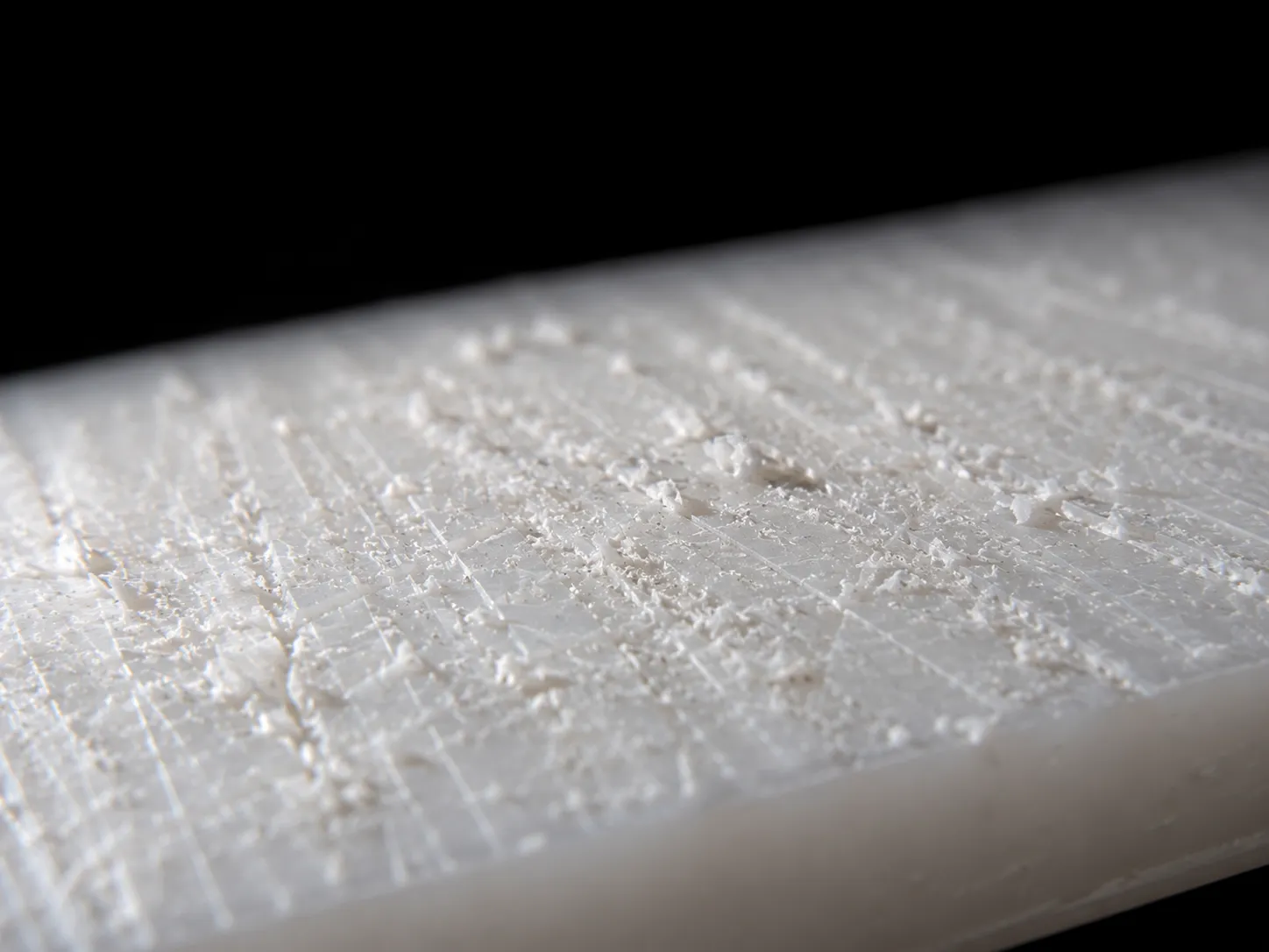 Macro close-up of plastic cutting board score marks